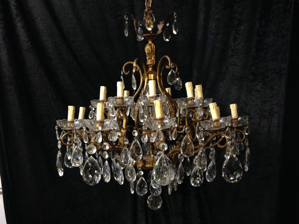 a large antique french brass and crystal chandelier