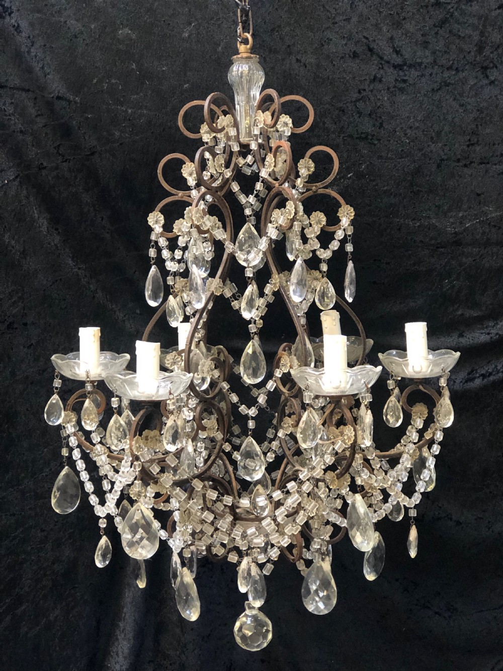 a six light dark framed florentine antique chandelier