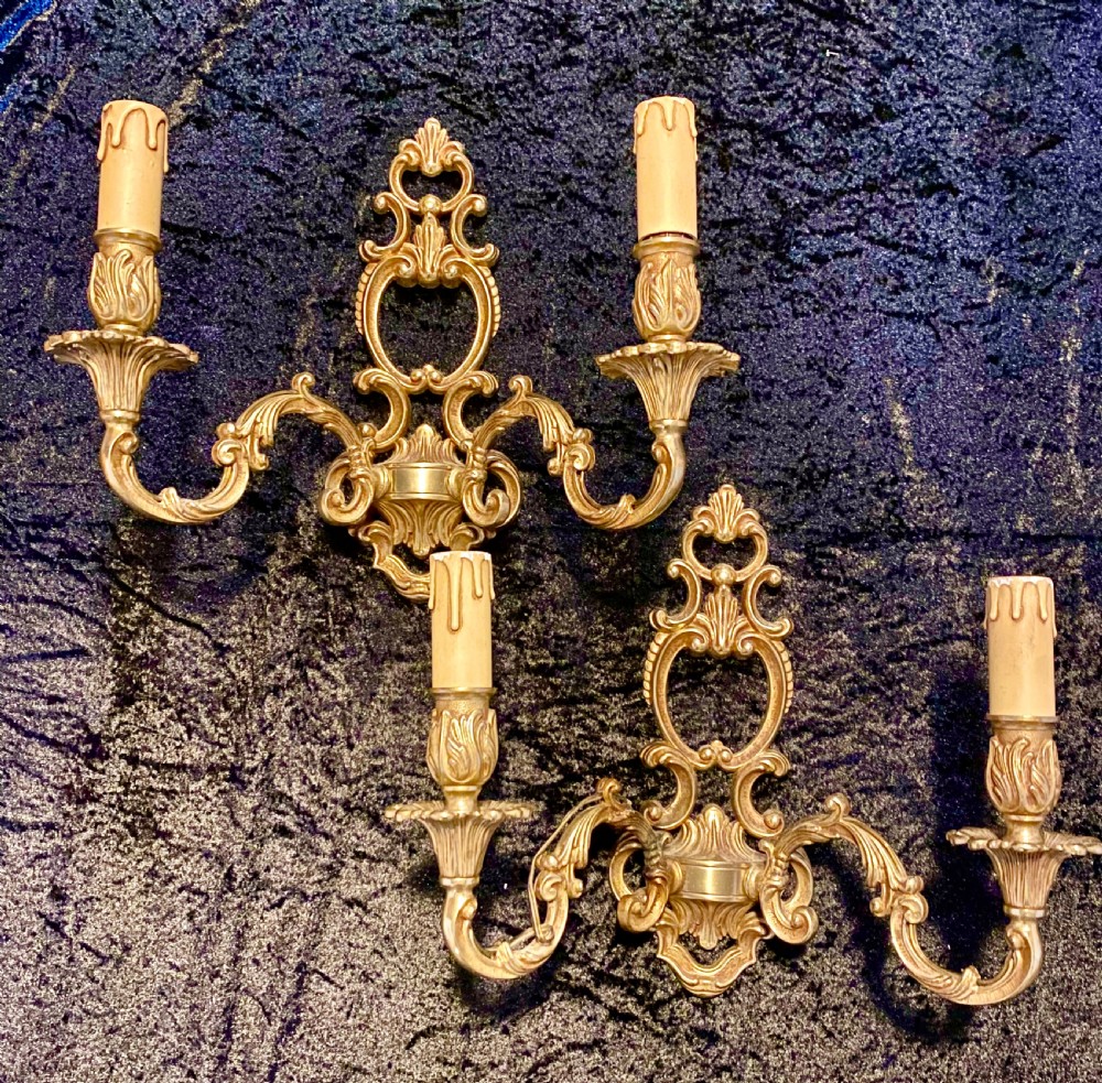a pair of two arm french brass walllights with open frame
