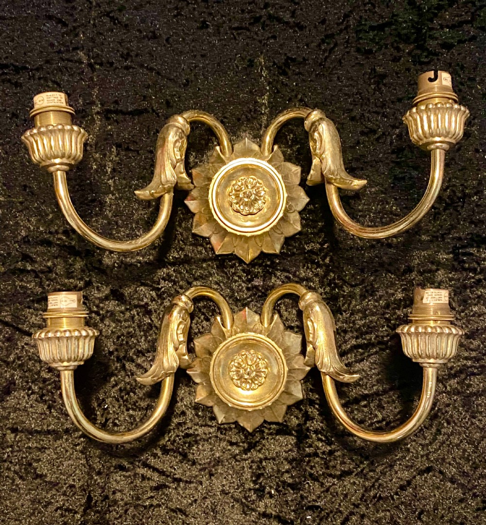 a pair of two light french brass walllights